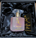 Perfume bottle with 'SL' logo in a black box on a brown surface